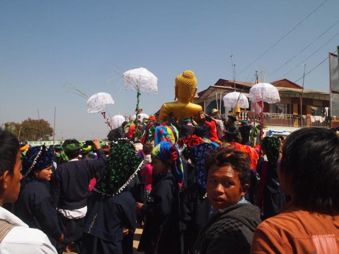 the crowds carry the Buddha